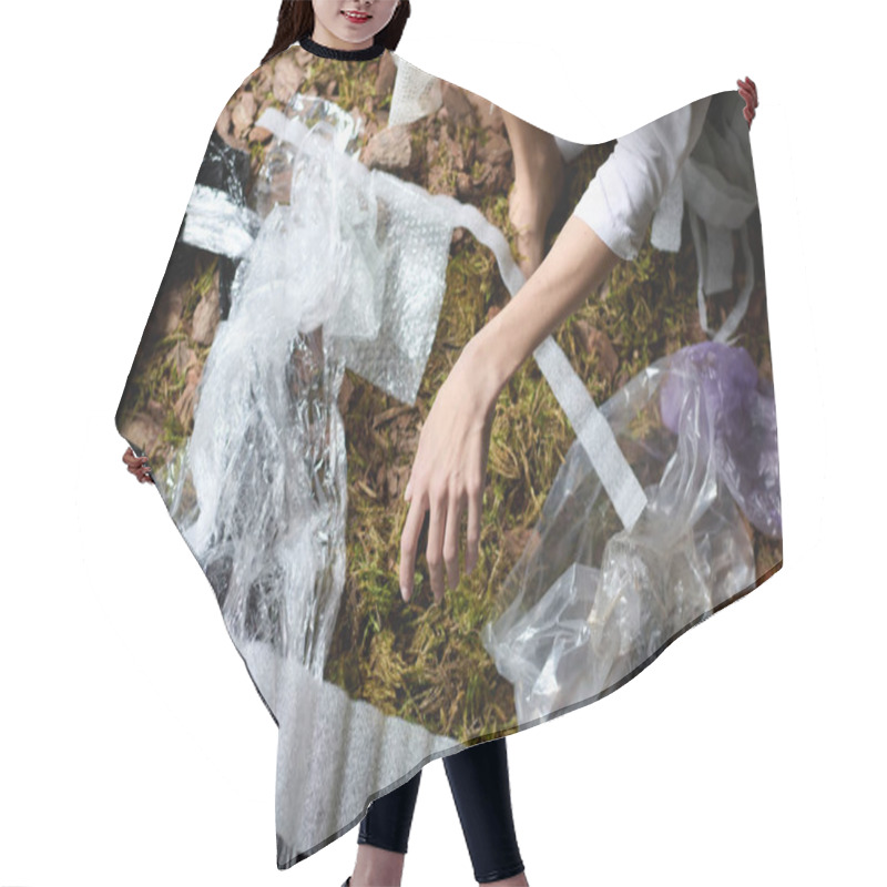 Personality  A Woman In Aesthetic Attire Poses Amidst A Swamp Filled With Plastic Garbage. Hair Cutting Cape