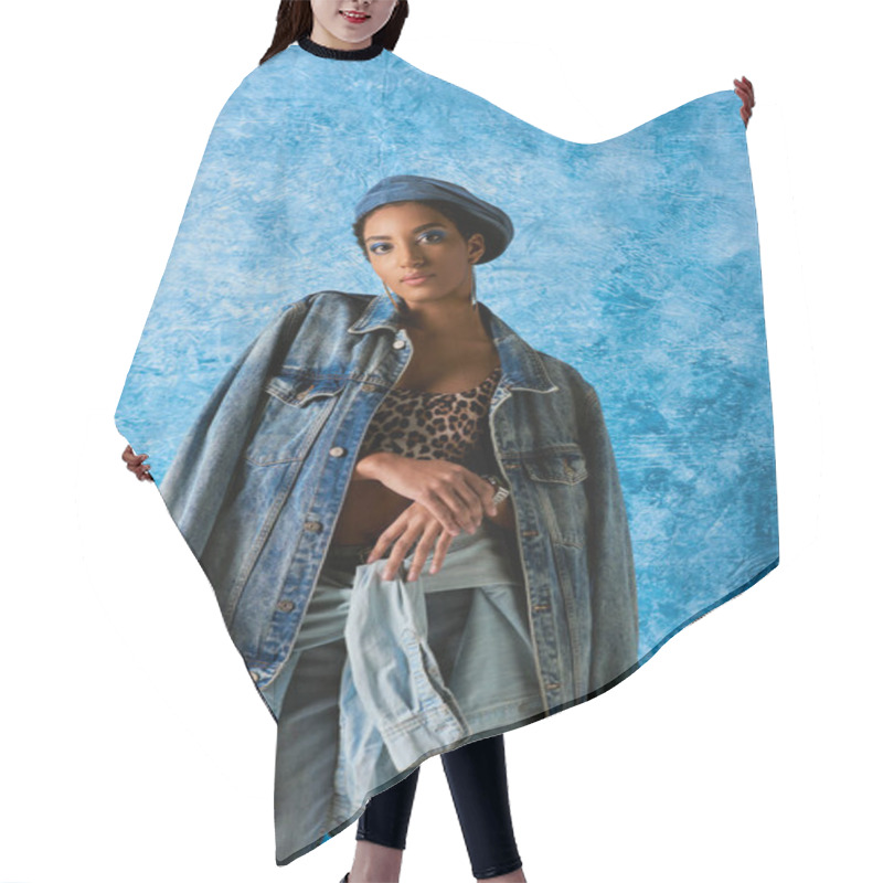 Personality  Young African American Woman In Beret Looking At Camera While Posing In Denim Clothes And Top With Animal Pattern On Blue Textured Background, Stylish Denim Attire Hair Cutting Cape