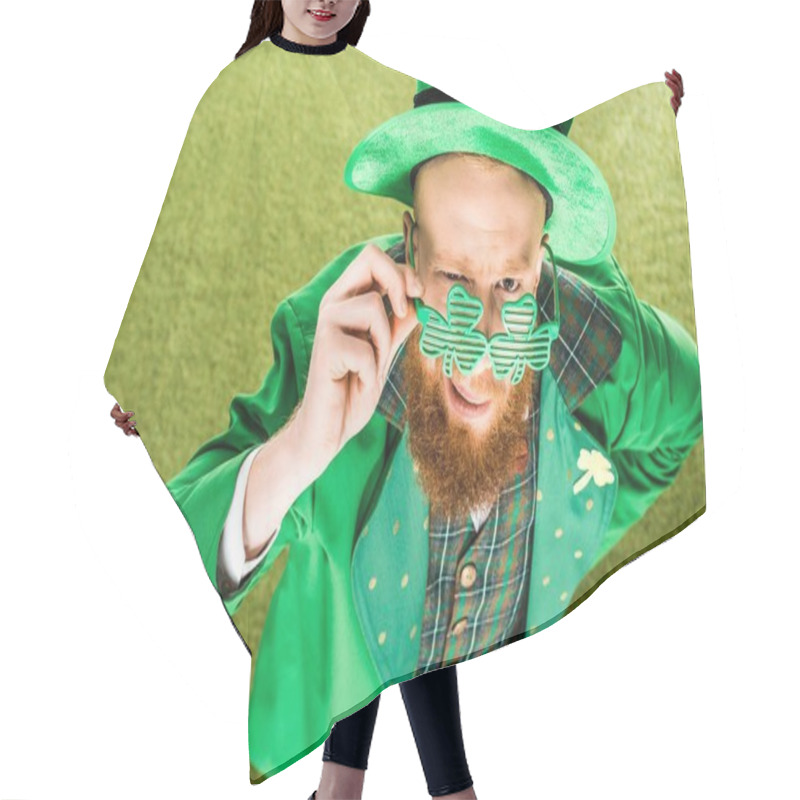 Personality  High Angle View Of Bearded Man In Green Costume Wearing Clover Shaped Eyeglasses And Looking At Camera, St Patricks Day Concept Hair Cutting Cape