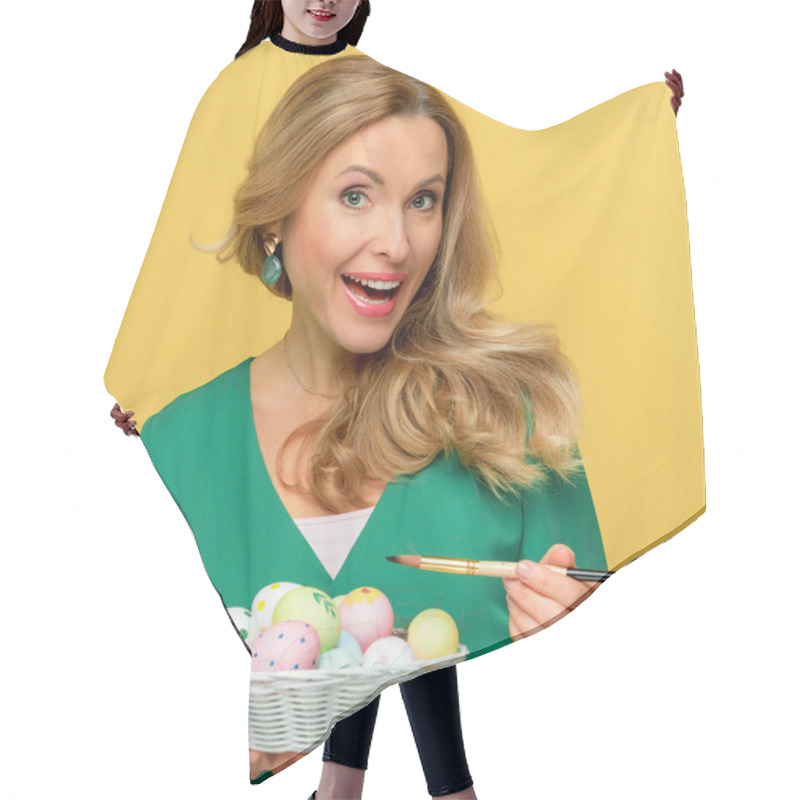 Personality  Beautiful Woman With Opened Mouth Holding Paintbrush Near Easter Eggs Isolated On Yellow  Hair Cutting Cape