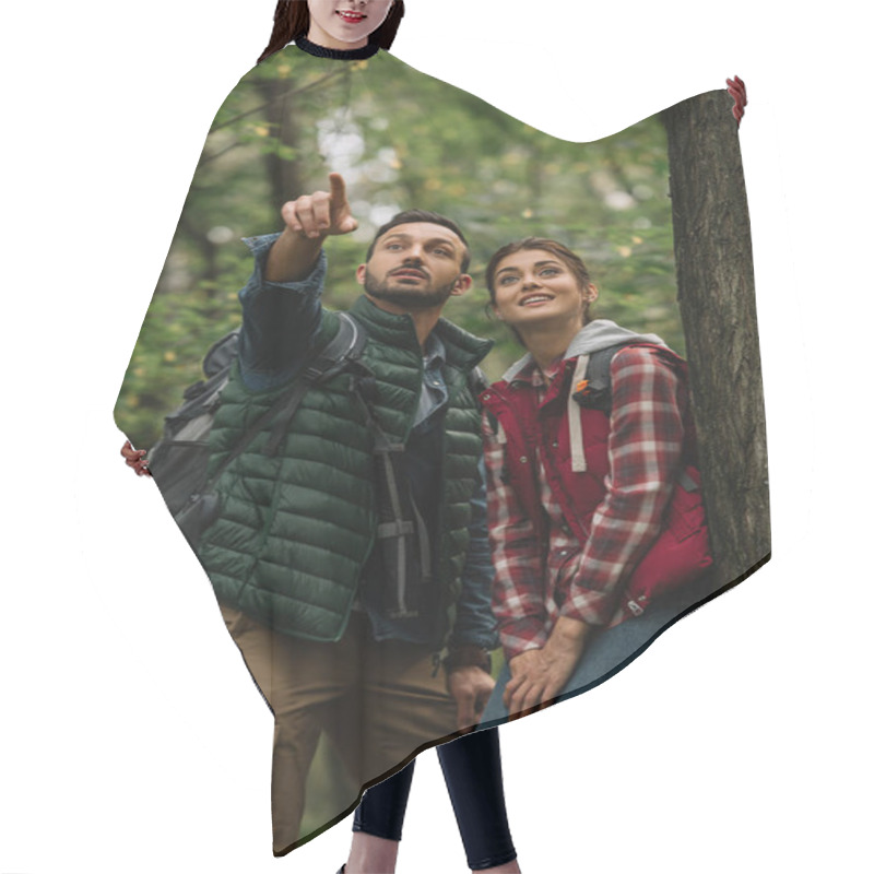 Personality  Portrait Of Man And Woman With Backpacks Looking Away While Hiking In Woods Hair Cutting Cape