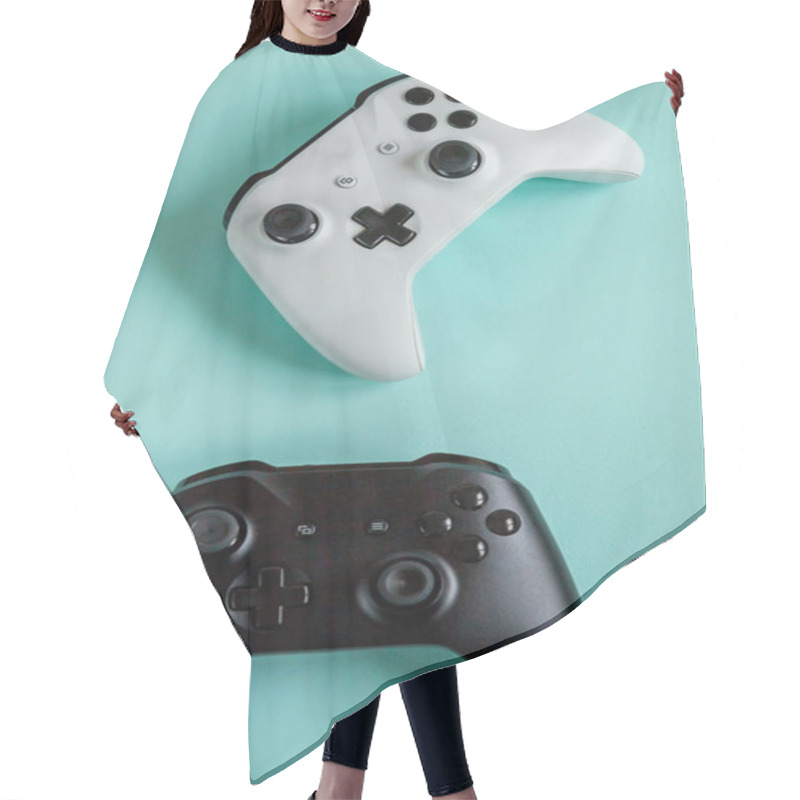 Personality  White And Black Two Joystick Gamepad, Game Console Isolated On Pastel Blue Colourful Trendy Background. Computer Gaming Competition Videogame Control Confrontation Concept. Cyberspace Symbol Hair Cutting Cape