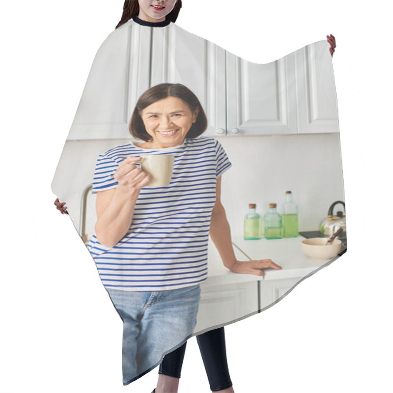 Personality  A Woman In Cozy Homewear Stands In A Kitchen, Holding A Cup. Hair Cutting Cape