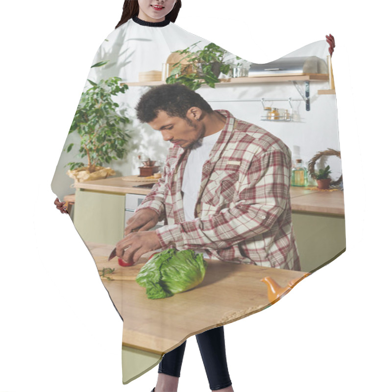 Personality  Handsome Young Man Chops Vegetables While Surrounded By Plants And Kitchen Tools. Hair Cutting Cape