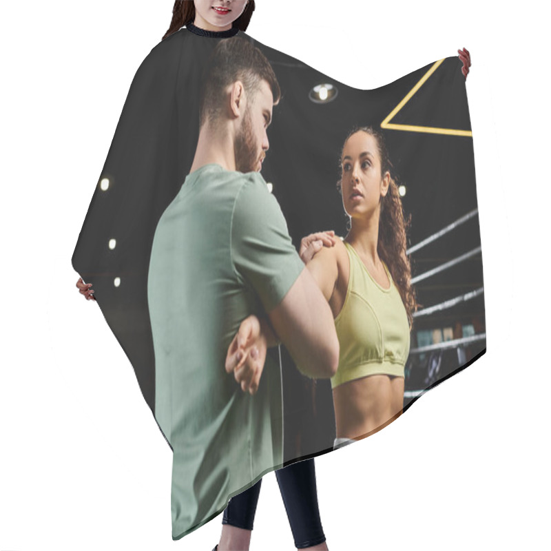 Personality  A Male Trainer Demonstrates Self-defense Techniques To A Woman In A Gym Setting. Hair Cutting Cape