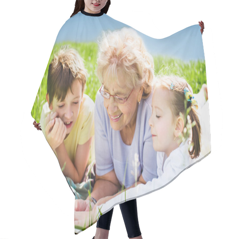 Personality  Grandmother Reading Book To Grandchildren Outdoors Hair Cutting Cape