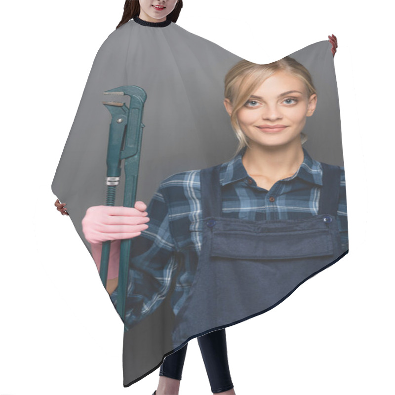 Personality  Young Blonde Plumber In Plaid Shirt And Overalls Holding Pipe Wrench On Grey Background Hair Cutting Cape