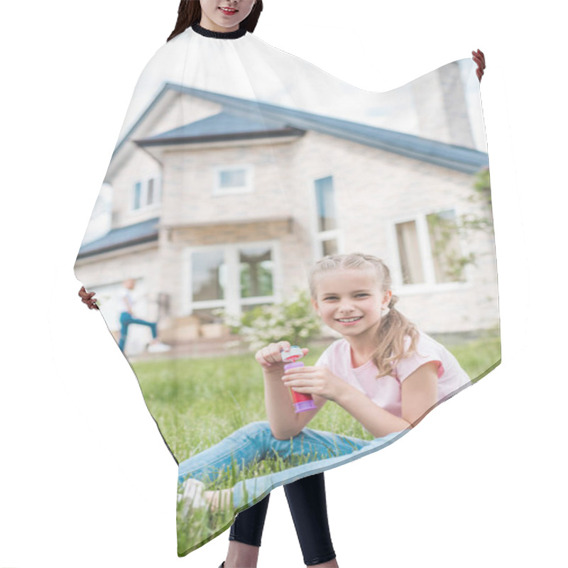 Personality  Adorable Little Child With Soap Bubbles Sitting On Lawn While Her Mother Standing Behind In Front Of House  Hair Cutting Cape