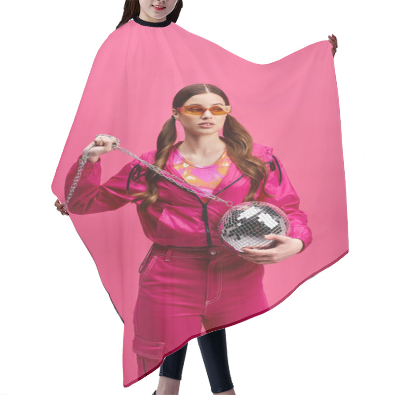 Personality  A Vibrant Woman In Her 20s, Donning A Stylish Pink Outfit, Holds A Disco Ball, Exuding Energy Against A Pink Backdrop. Hair Cutting Cape