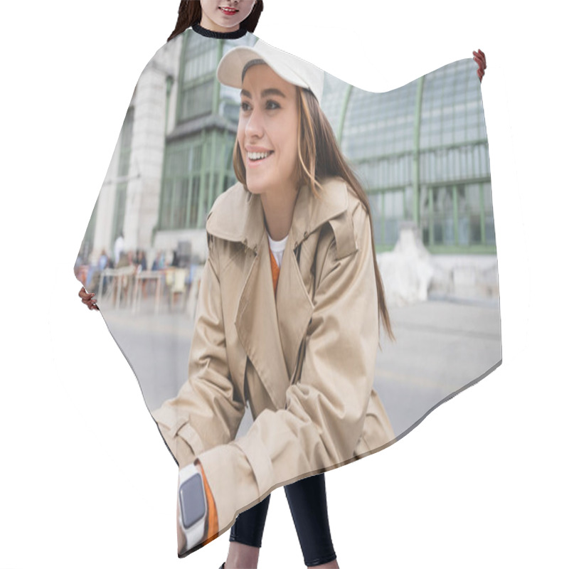 Personality  Joyful Young Woman In Beige Trench Coat And Baseball Cap Looking Away Hair Cutting Cape