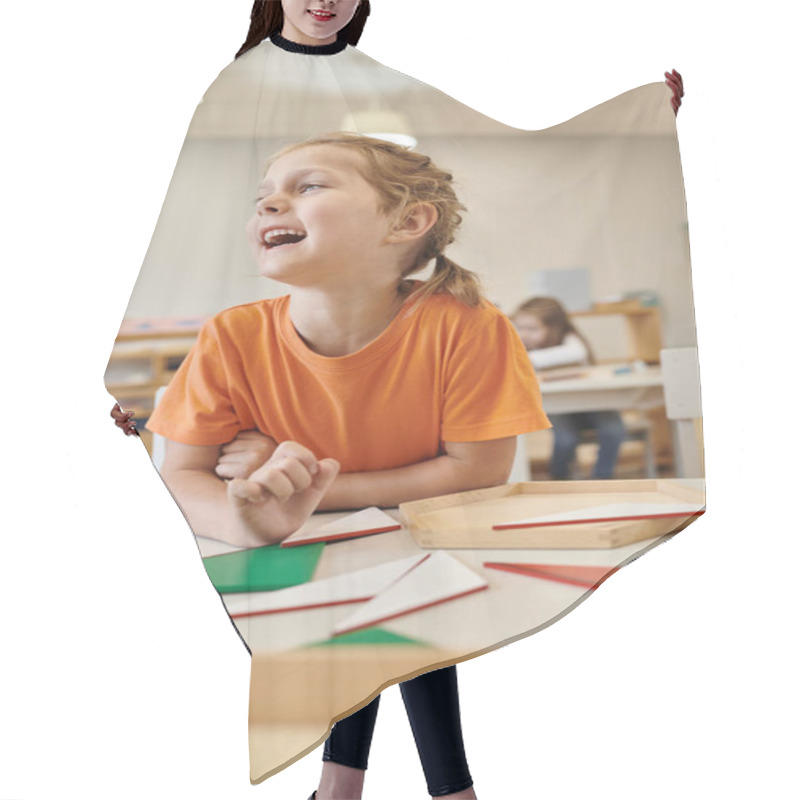 Personality  Happy Child Looking Away Near Wooden Didactic Materials In Class Of Montessori School Hair Cutting Cape