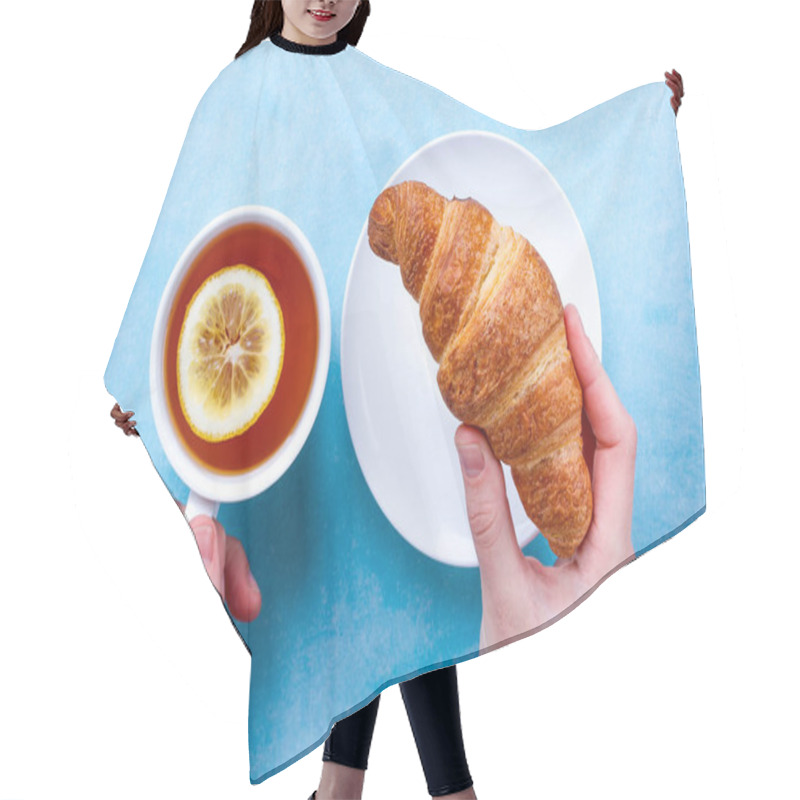 Personality  Freshly Baked Croissants And A Cup Of Hot Tea With Lemon In Hand For French Breakfast On A Blue Background. Top View  Hair Cutting Cape