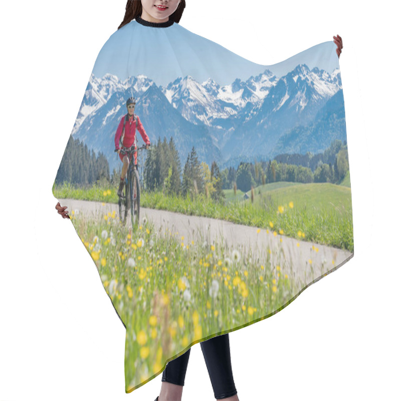 Personality  Pretty Senior Woman Riding Her Electric Mountain On Warm Spring Day With Snoe Capped Bike In The Iller Valley Near Oberstdorf With Snoe Capped Allgau High Alps In Background, Allgau Alps, Bavaria,  Hair Cutting Cape