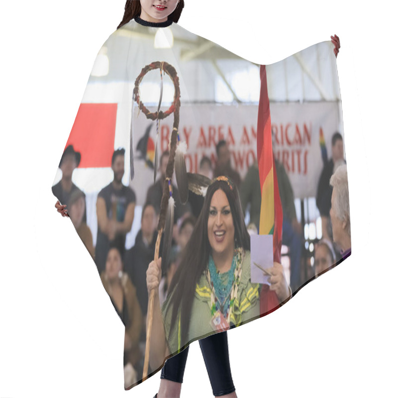 Personality  San Francisco, USA - February 08 2020: Native American Indian Two Spirit Person Holds A Traditional Grand Entry Eagle Staff And Rainbow Flag At Powwow Hair Cutting Cape