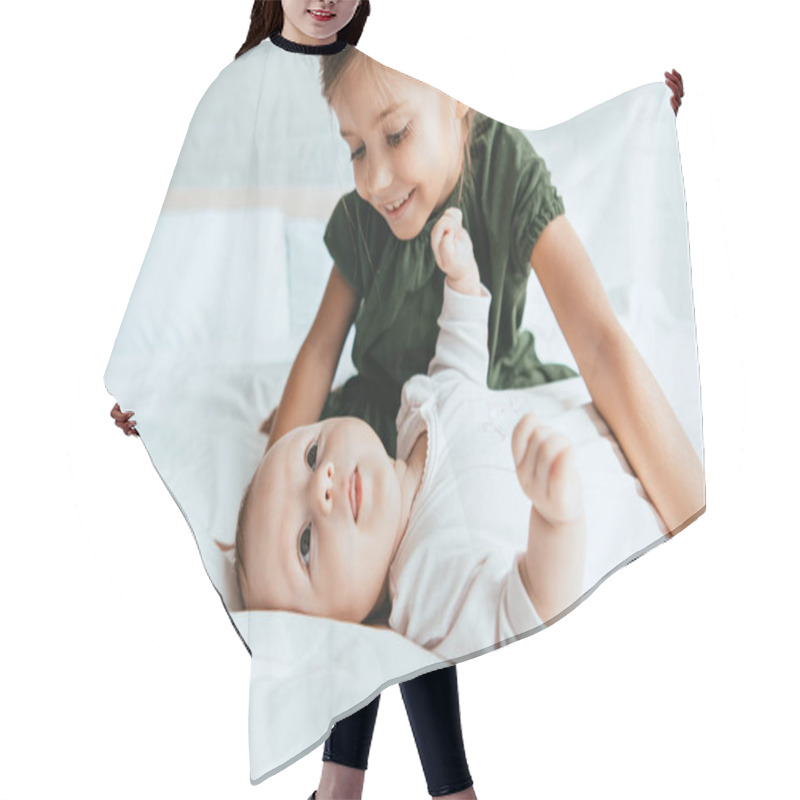 Personality  Smiling Child Looking At Adorable Infant Lying On White Bedding Hair Cutting Cape