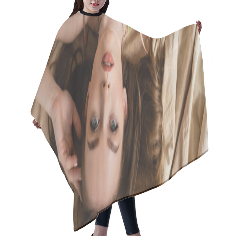 Personality  Top View Of Alluring And Brunette Young Woman Lying On Linen Fabric And Looking At Camera On Beige Background, Sensuality, Upside Down View, Banner  Hair Cutting Cape