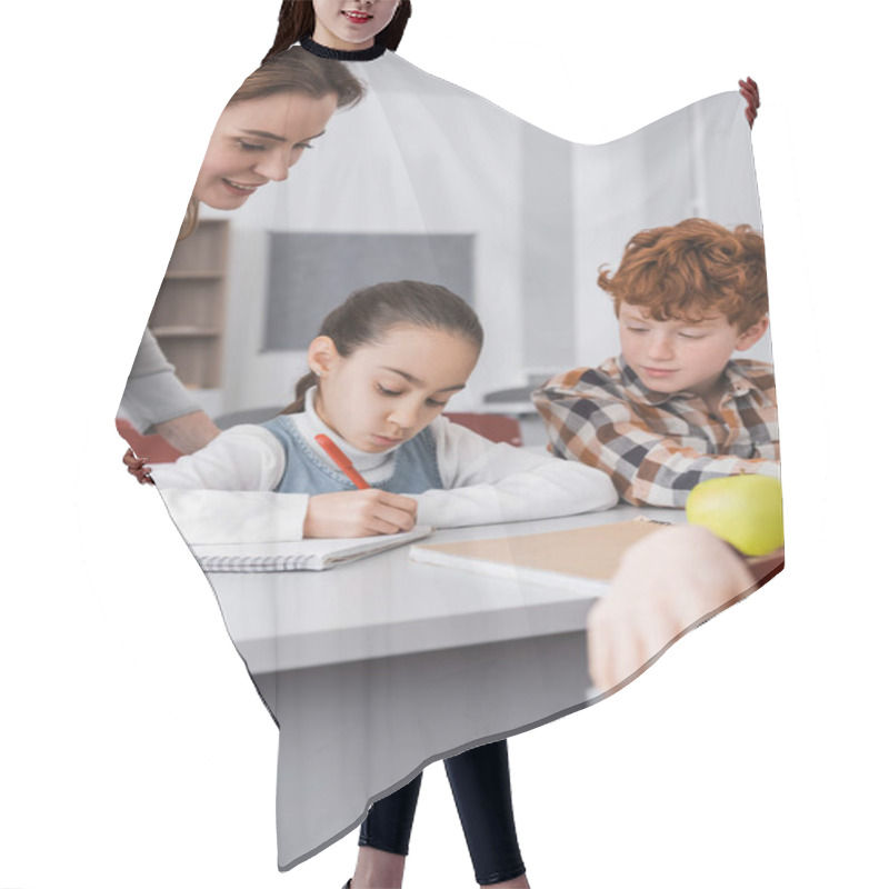 Personality  Smiling Teacher Near Schoolgirl Writing In Notebook During Lesson Hair Cutting Cape