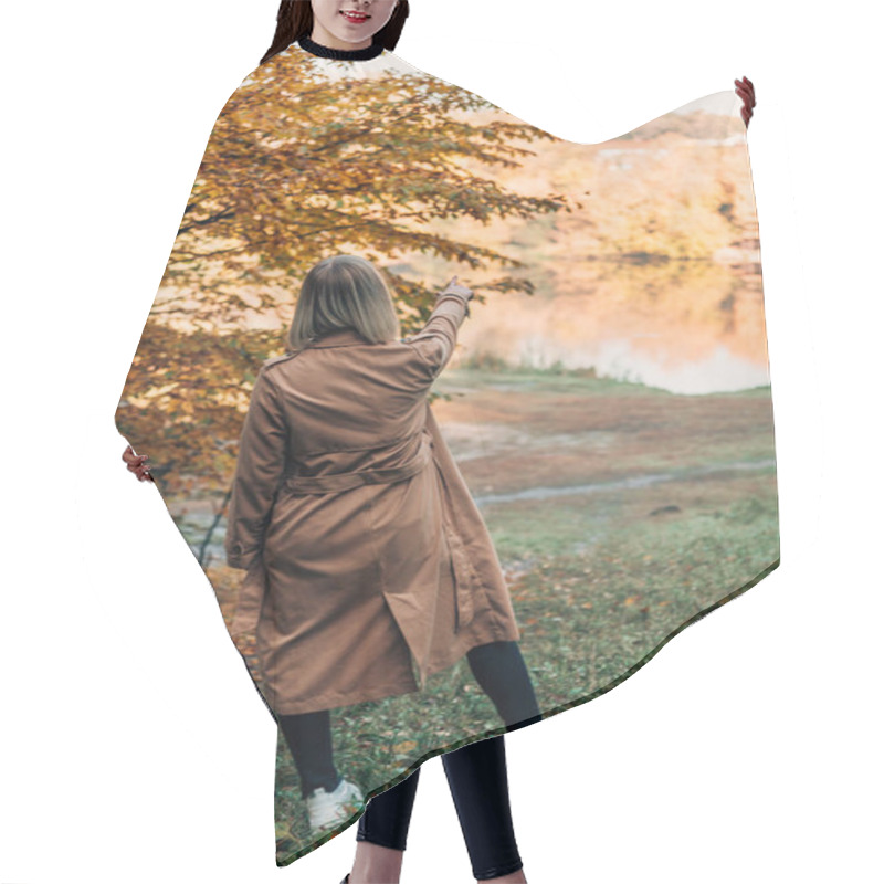 Personality  Back View Of Woman Standing In Coat And Pointing At Lake In Autumn Forest  Hair Cutting Cape