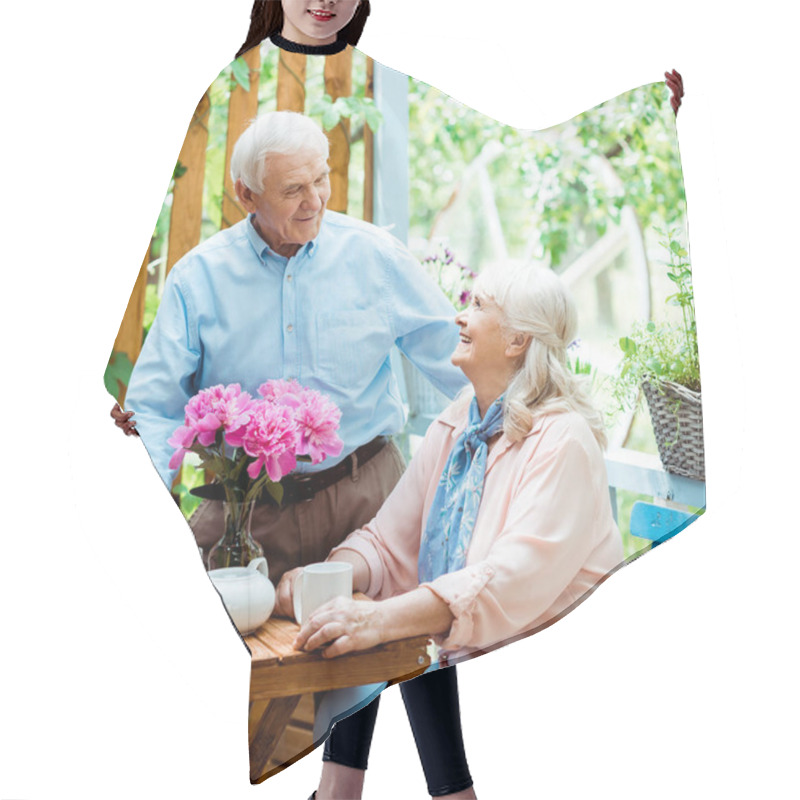 Personality  Happy Senior Man Standing And Looking At Cheerful Wife Near Cups  Hair Cutting Cape