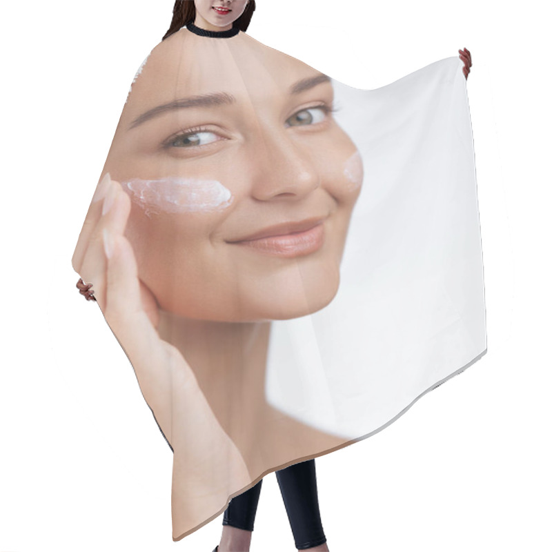 Personality  A Smiling Woman With A Towel Wrapped Around Her Hair Gently Applies Skincare Cream To Her Face, Highlighting The Importance Of A Daily Beauty Routine. Perfect For Promoting Skincare, Self-care, And Hair Cutting Cape