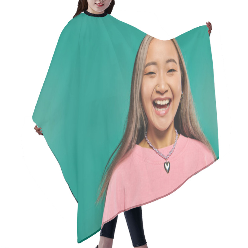 Personality  Portrait Of Cheerful And Young Asian Girl In Pink Sweatshirt Posing On Turquoise Background Hair Cutting Cape