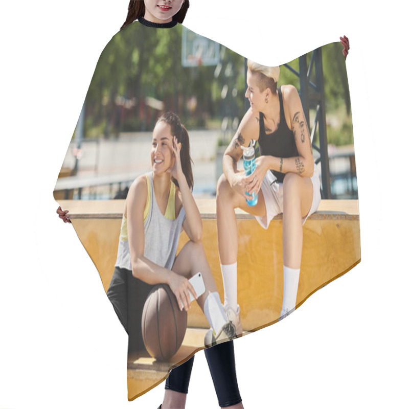 Personality  Two Young Women In Athletic Gear Sitting On Steps, Playing Basketball Outdoors On A Sunny Day. Hair Cutting Cape