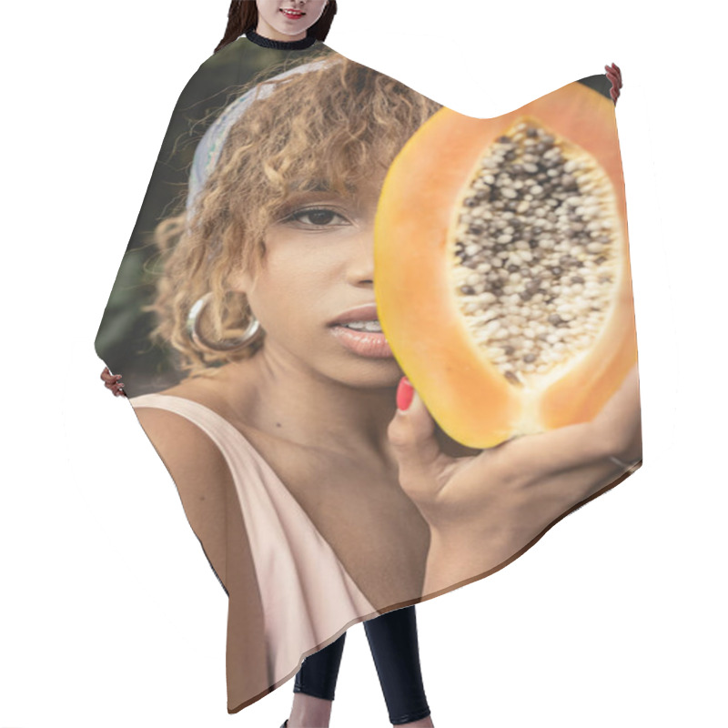 Personality  Portrait Of Young And Fashionable African American Woman In Headscarf And Summer Dress Holding Cut And Ripe Papaya And Covering Face Near Plants, Stylish Lady Blending Fashion And Nature Hair Cutting Cape