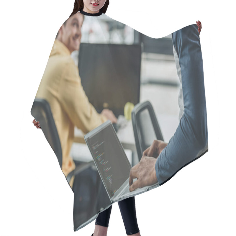 Personality  Cropped View Of African American Programmer Working While Sitting On Desk Near Smiling Colleague Hair Cutting Cape