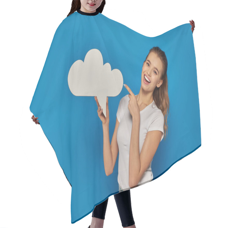 Personality  Amazed Young Woman Smiling And Pointing At Blank Placard On Blue Backdrop, Holding Thought Bubble Hair Cutting Cape