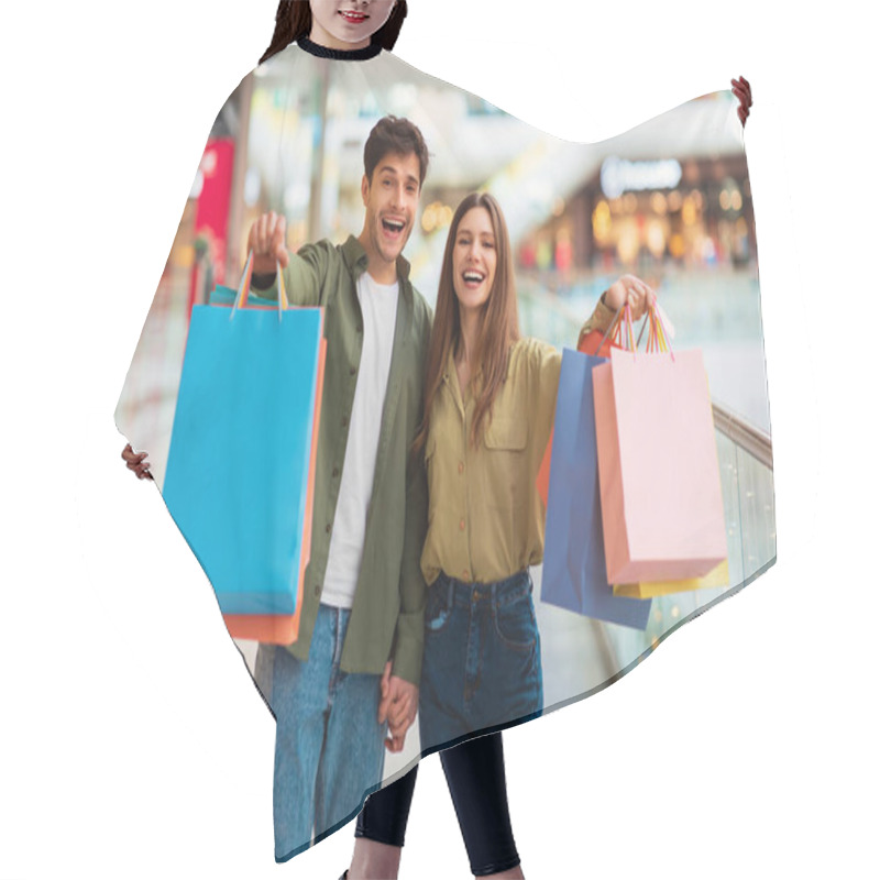 Personality  Cheerful Spouses Showing Shopping Bags To Camera Standing In Mall Hair Cutting Cape