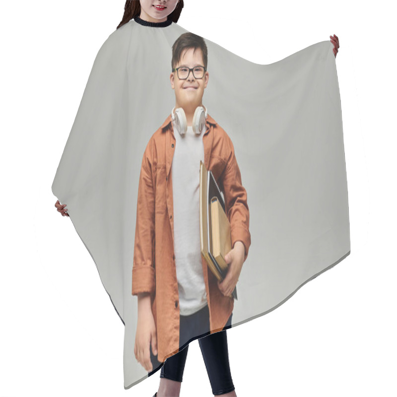 Personality  Little Boy With Down Syndrome Holding A Books And Wearing Glasses. Hair Cutting Cape