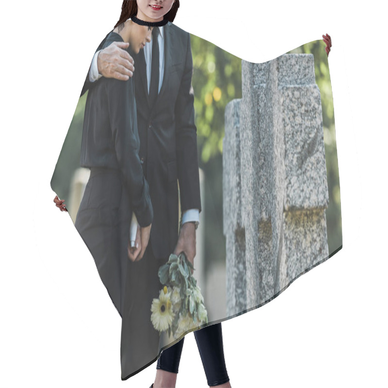 Personality  Cropped View Of Senior Man Holding Flowers While Hugging Woman Near Tombs  Hair Cutting Cape