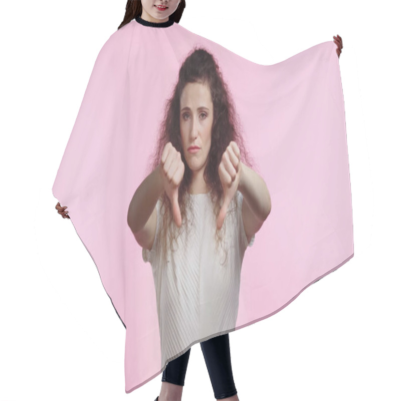 Personality  Displeased Young Woman Showing Thumbs Down Isolated On Pink Hair Cutting Cape