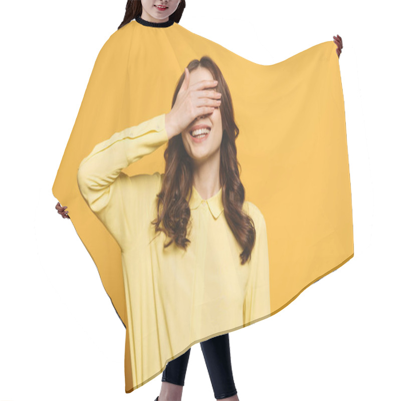 Personality  Smiling Girl Covering Eyes With Hand On Yellow Background Hair Cutting Cape