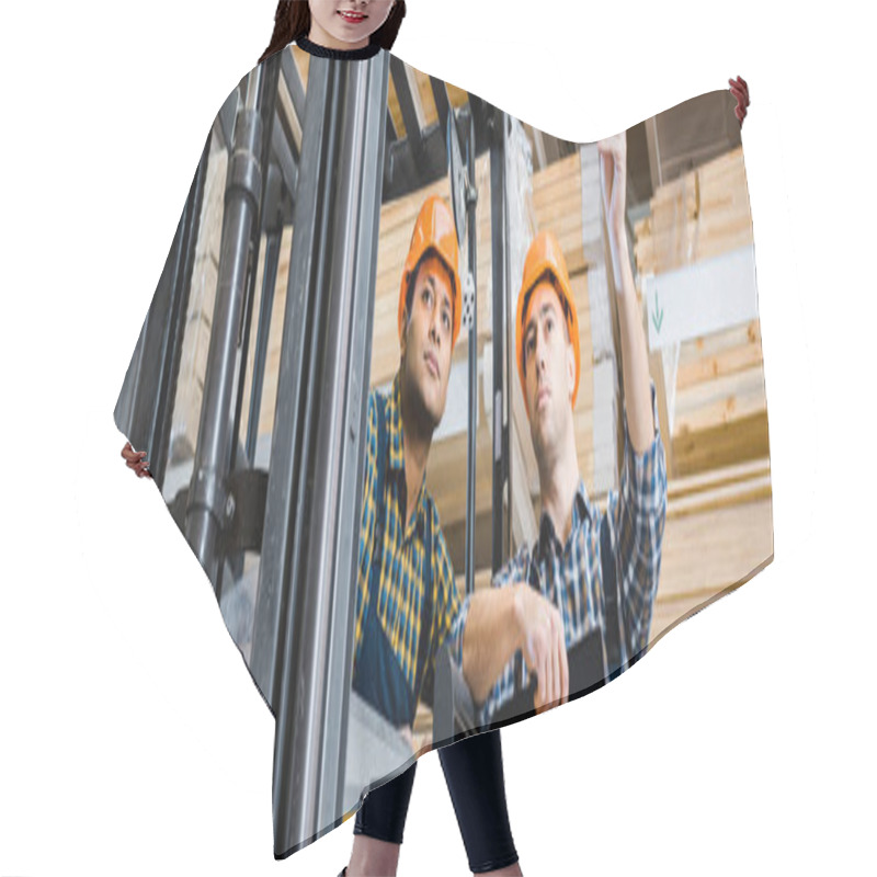 Personality  Panoramic Shot Of Warehouse Worker Pointing With Pencil Near Indian Colleague Hair Cutting Cape