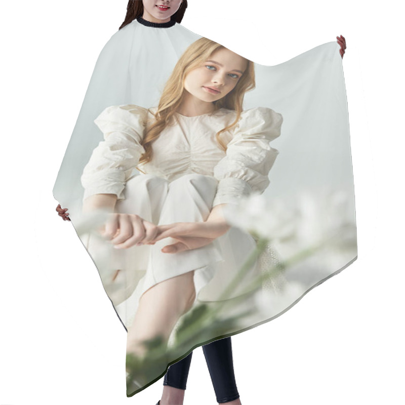 Personality  A Beautiful Young Woman Sits Gracefully With Soft Flowers Nearby. Hair Cutting Cape