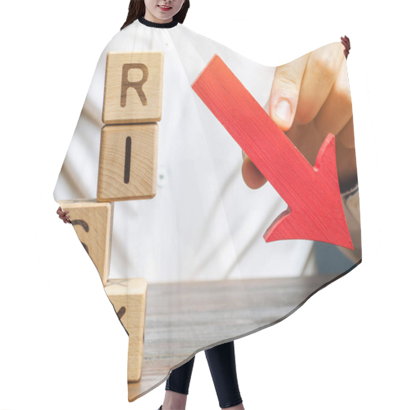 Personality  Wooden Blocks With The Word Risk And A Down Arrow. Reduce Financial Risk For Investment And Capital. Protection Of Investment Funds And Assets. Deposit Insurance. Debt Restructuring. Assessment Hair Cutting Cape