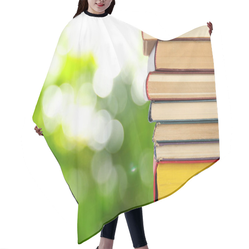 Personality  Collection Of Different Books Against Blurred Green Background, Space For Text Hair Cutting Cape