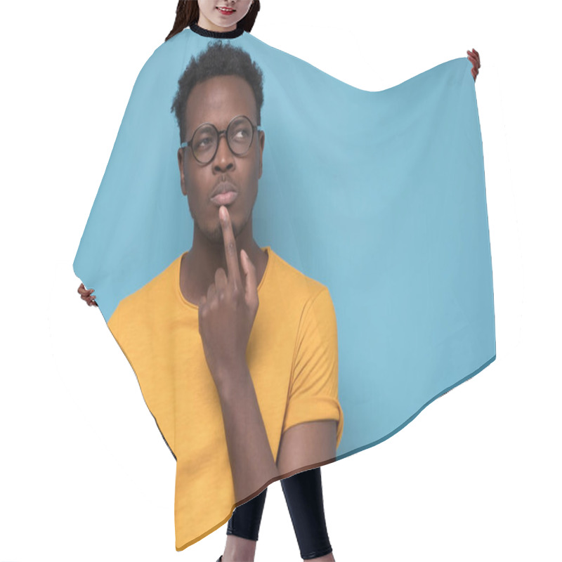 Personality  Young African American Man, Student With Finger In Mouth In Deep Thought, Isolated On Blue Background. Negative Emotion, Facial Expression, Feelings Hair Cutting Cape