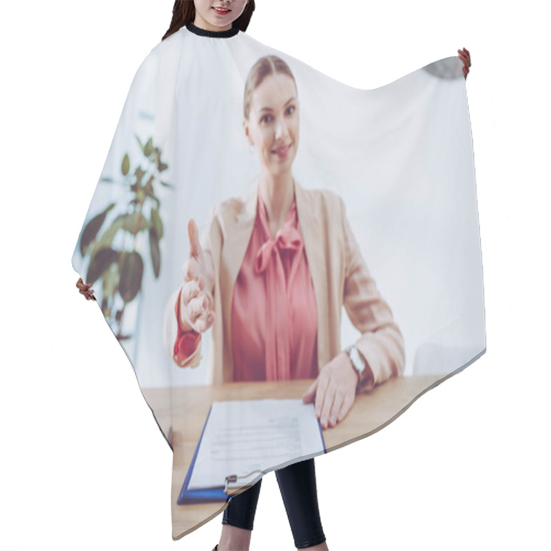 Personality  Selective Focus Of Hand Of Attractive Recruiter Sitting Near Clipboard  Hair Cutting Cape