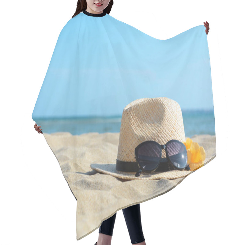 Personality  Hat With Beautiful Sunglasses And Flowers On Sand Near Sea. Space For Text Hair Cutting Cape