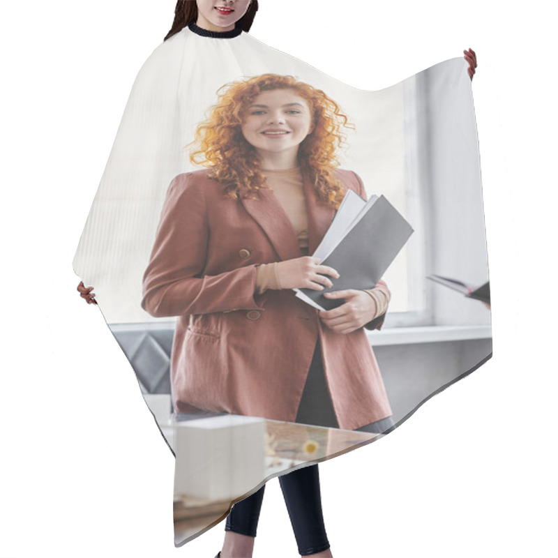 Personality  Portrait Of Redhead Architect With Documents Smiling At Camera Near Modern Building Model In Office Hair Cutting Cape