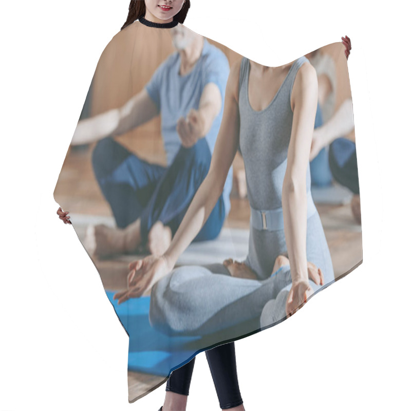 Personality  Cropped Shot Of Female Instructor With Senior People Sitting In Lotus Position On Yoga Mats  Hair Cutting Cape