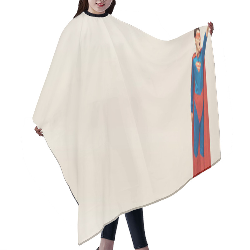 Personality  Asian Boy In Superhero Costume With Cloak And Mask Screaming While Showing Strength Gesture While Standing With Outstretched Hand During Child Protection Day On Grey Background, Banner  Hair Cutting Cape