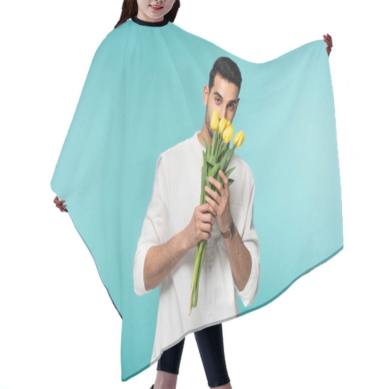 Personality  Young Arabian Man In White Shirt Holding Yellow Flowers Isolated On Blue  Hair Cutting Cape