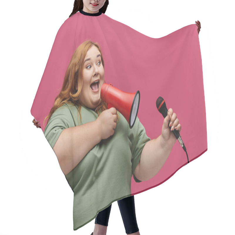 Personality  A Woman In A Green Shirt Speaks Through A Megaphone And Holds A Microphone. Hair Cutting Cape