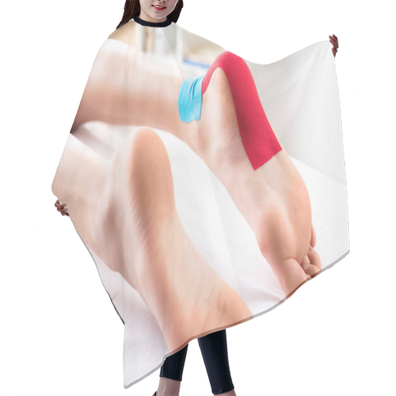 Personality  Cropped View Of Woman Lying On Massage Couch With Kinesiology Tapes On Foot Hair Cutting Cape