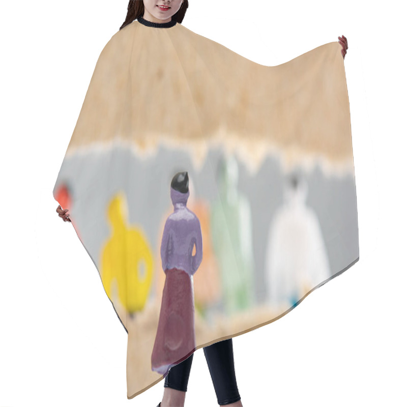 Personality  Selective Focus Of Toy Near Hole In Cardboard With People Figures Isolated On Grey, Concept Of Social Rights  Hair Cutting Cape