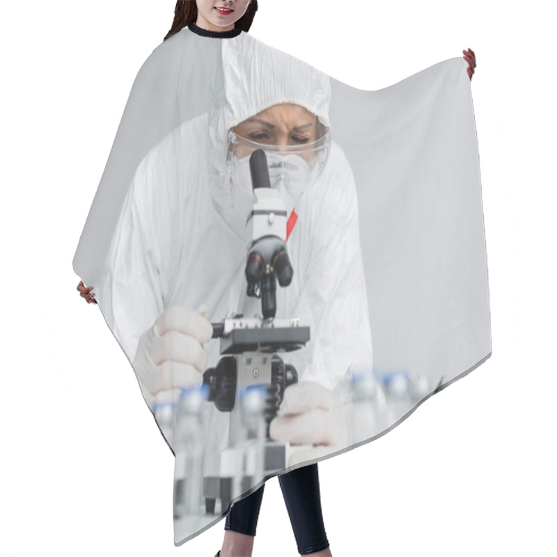 Personality  Scientist In Goggles And Hazmat Suit Looking At Microscope Near Vaccines On Blurred Foreground  Hair Cutting Cape