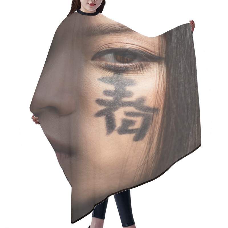 Personality  Close Up View Of Young Asian Woman With Hieroglyphs On Face Looking At Camera  Hair Cutting Cape